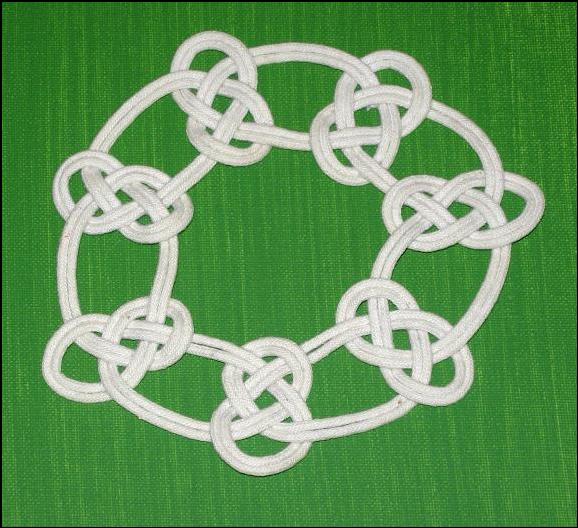 Flat knot designed based upon the Carrick Bend on-the-bight.  (Sailor's Breastplate Knot.)