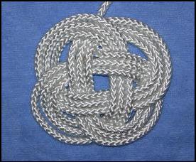 A 3 lead by 4 bight knot tied in a flat pattern.